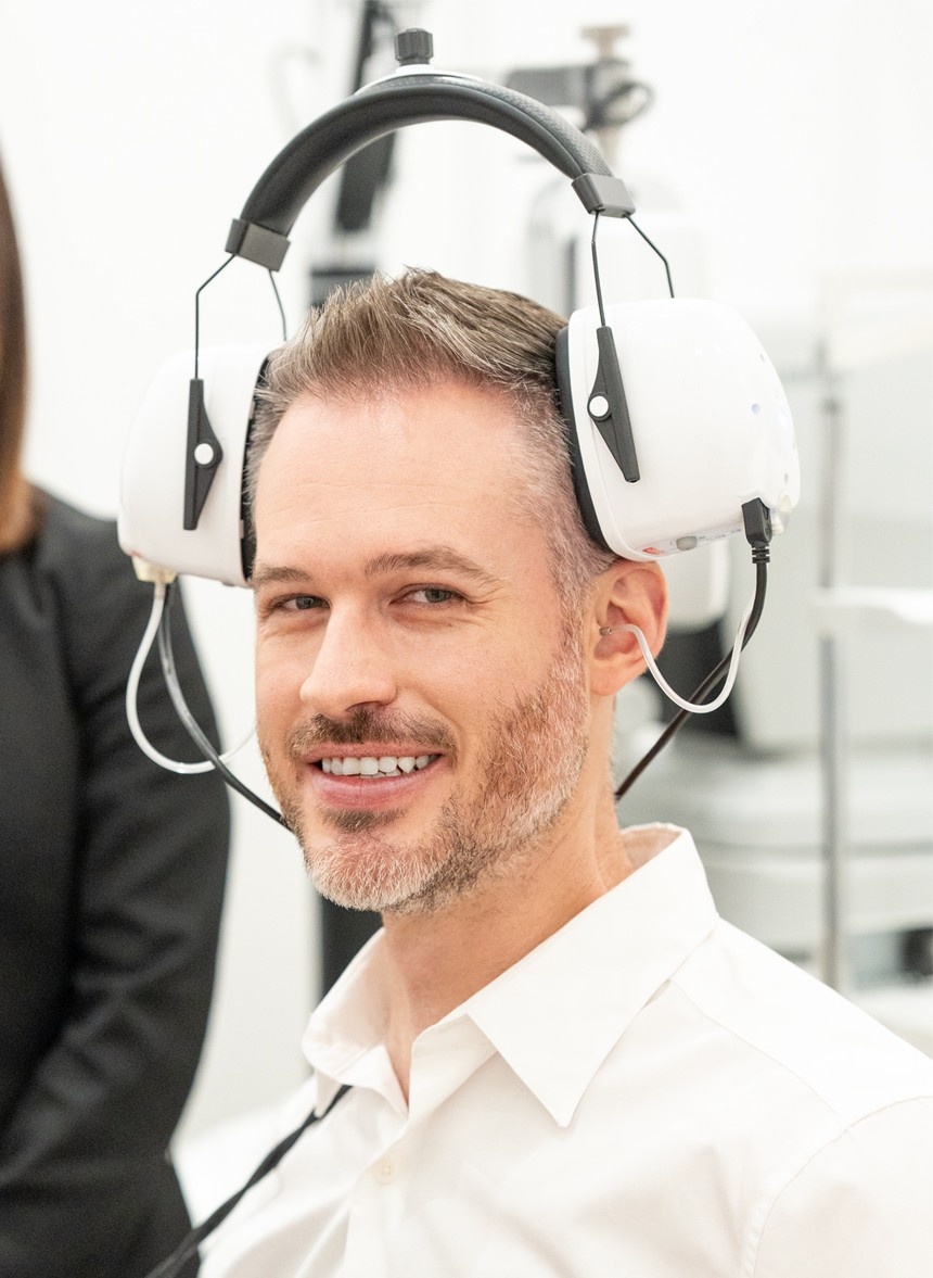 Torga audiologist conducting a professional hearing screening in-store